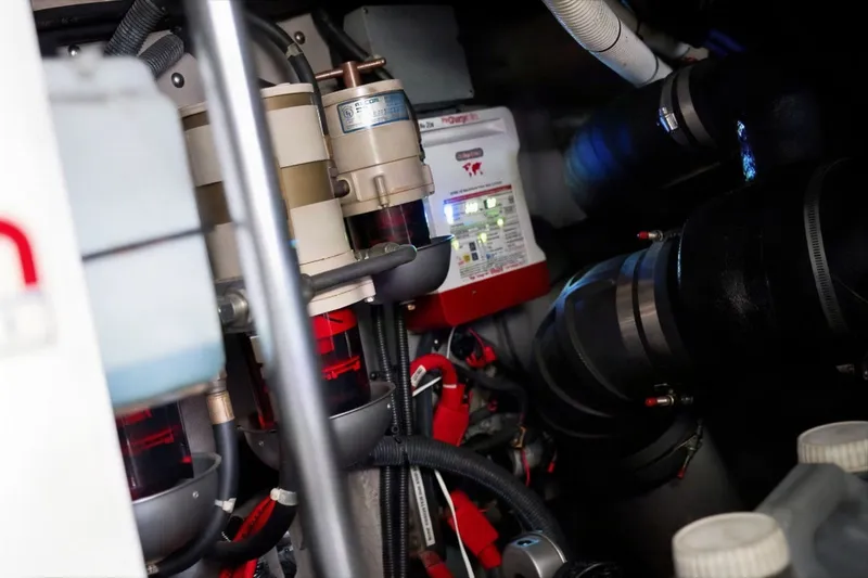 Slide: The Image of Engine room of 2003 Sea Ray 450 Express Bridge with visible components and wiring. - 89