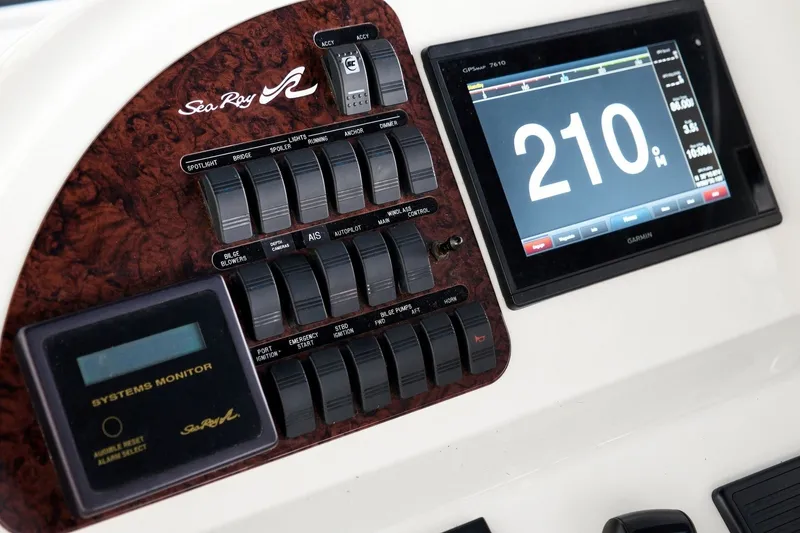 Slide: The Image of Control panel of a 2003 Sea Ray 450 Express Bridge with switches and Garmin display. - 40