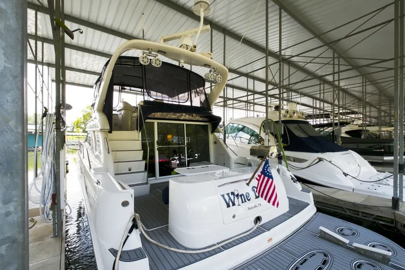 Slide: The Image of 2003 Sea Ray 450 Express Bridge yacht docked in a covered marina. - 25