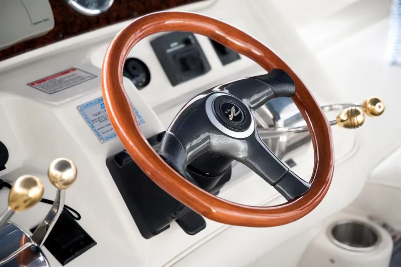 Slide: The Image of Steering wheel of 2003 Sea Ray 450 Express Bridge yacht with wooden accents. - 28