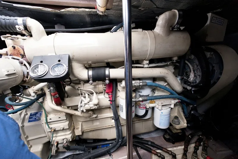 Slide: The Image of Engine compartment of a 2003 Sea Ray 450 Express Bridge, showcasing mechanical components and gauges. - 76