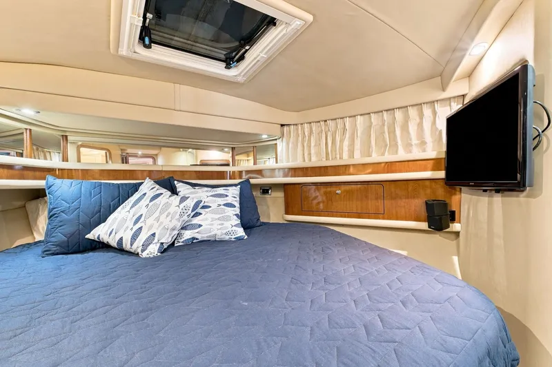 Slide: The Image of Luxurious cabin interior of 2003 Sea Ray 450 Express Bridge yacht with cozy bedding. - 60