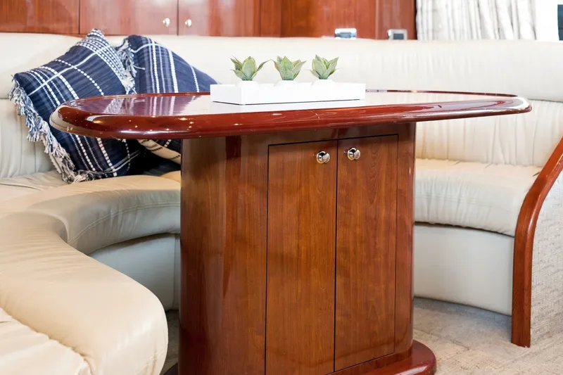 Slide: The Image of Luxurious interior of 2003 Sea Ray 450 Express Bridge with elegant wood table and plush seating. - 46