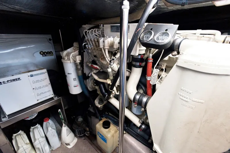 Slide: The Image of Engine room of a 2003 Sea Ray 450 Express Bridge with mechanical components and gauges. - 77