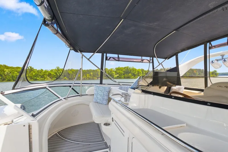 Slide: The Image of 2003 Sea Ray 450 Express Bridge yacht interior with scenic lake view. - 15