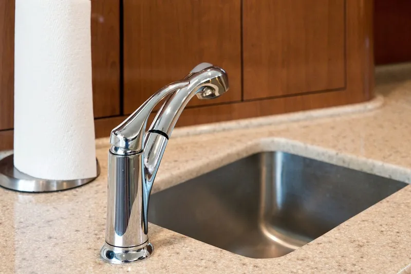 Slide: The Image of Chrome faucet and sink in 2003 Sea Ray 450 Express Bridge yacht kitchen. - 53