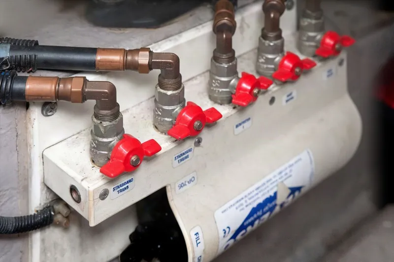 Slide: The Image of Red valve controls on a 2003 Sea Ray 450 Express Bridge boat system. - 82