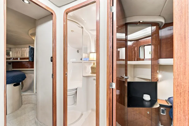 Slide: The Image of Interior of 2003 Sea Ray 450 Express Bridge yacht, featuring bedroom and bathroom. - 73