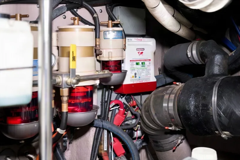 Slide: The Image of Engine room of 2003 Sea Ray 450 Express Bridge with fuel filters and hoses. - 90