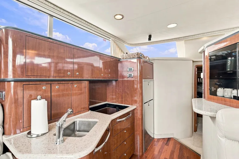 Slide: The Image of Luxurious 2003 Sea Ray 450 Express Bridge yacht interior with modern kitchen amenities. - 51
