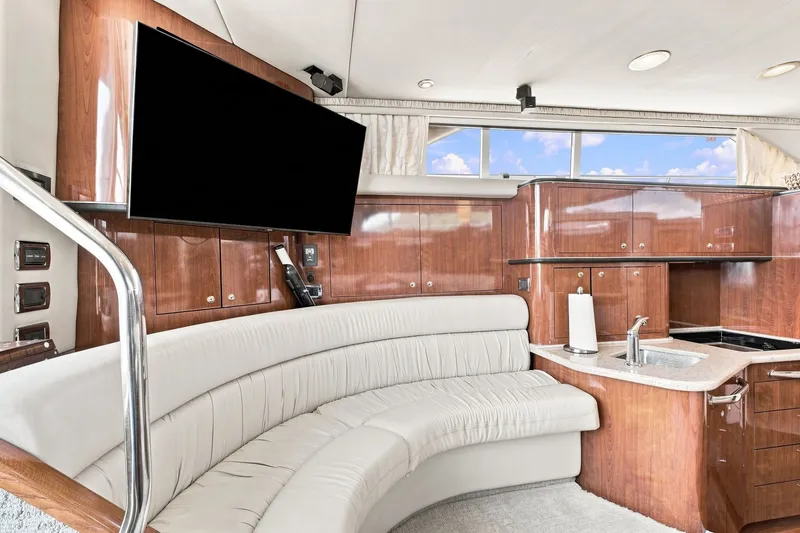 Slide: The Image of Luxurious interior of 2003 Sea Ray 450 Express Bridge with plush seating and modern amenities. - 48
