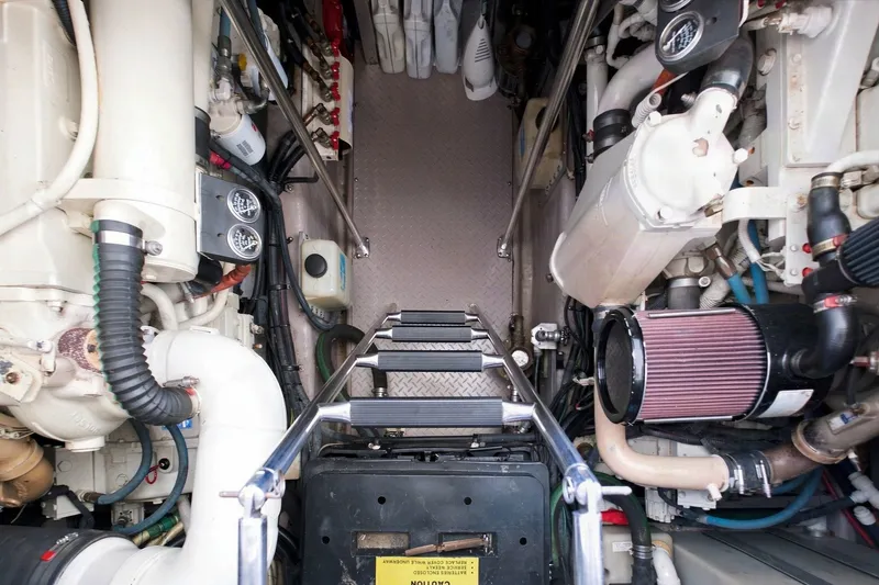 Slide: The Image of Engine room of a 2003 Sea Ray 450 Express Bridge yacht, showcasing mechanical components. - 74