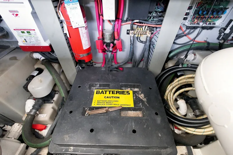 Slide: The Image of Engine room of 2003 Sea Ray 450 Express Bridge with battery compartment and fire extinguisher. - 75