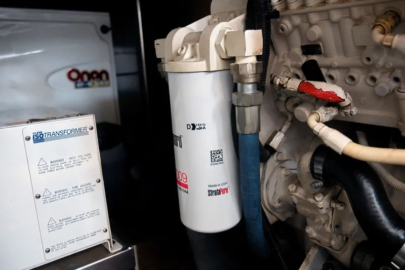 Slide: The Image of Engine compartment of a 2003 Sea Ray 450 Express Bridge with transformer and filter components. - 83