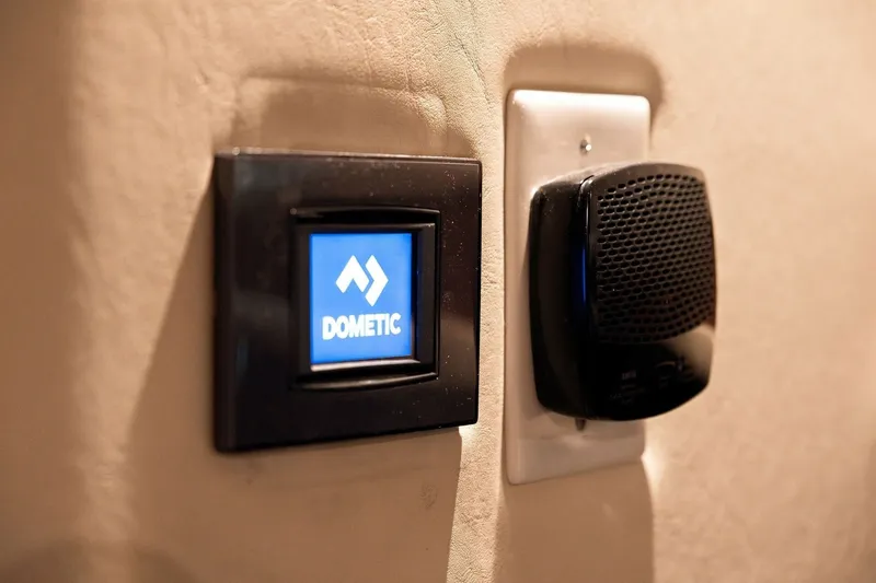 Slide: The Image of Dometic control panel and speaker on 2003 Sea Ray 450 Express Bridge yacht interior. - 71
