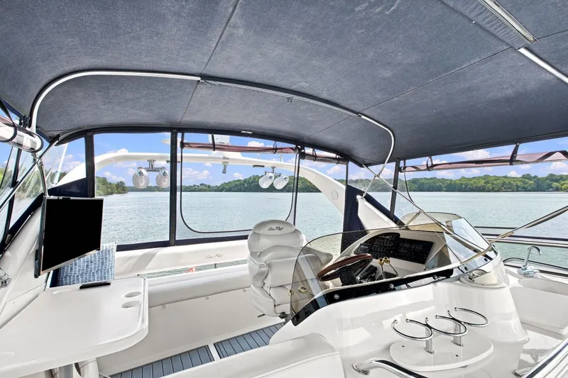 Slide: The Image of Interior view of 2003 Sea Ray 450 Express Bridge yacht with helm and seating area. - 18