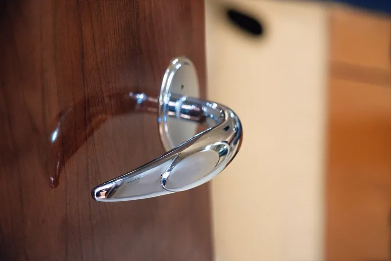 Slide: The Image of Chrome door handle on 2003 Sea Ray 450 Express Bridge yacht interior. - 70