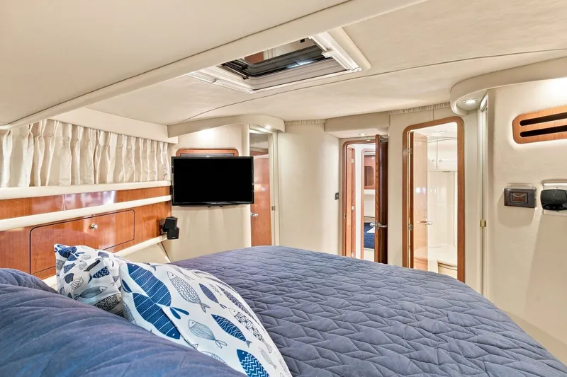 Slide: The Image of Luxurious interior of 2003 Sea Ray 450 Express Bridge yacht cabin with bed and TV. - 61