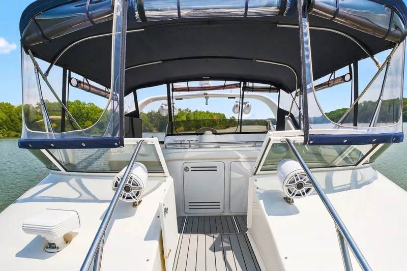 Slide: The Image of 2003 Sea Ray 450 Express Bridge yacht deck with canopy and speakers on a sunny day. - 21