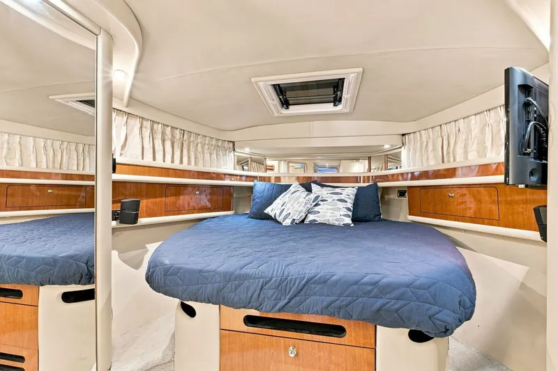 Slide: The Image of Luxurious cabin interior of 2003 Sea Ray 450 Express Bridge yacht with cozy bedding. - 59