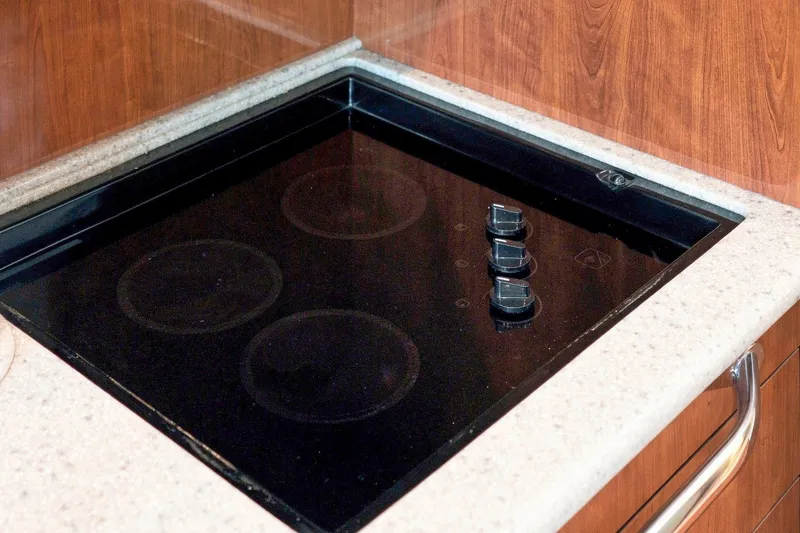 Slide: The Image of Built-in stovetop on 2003 Sea Ray 450 Express Bridge yacht kitchen. - 56