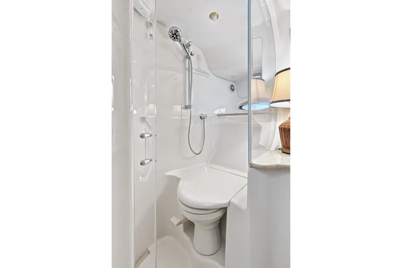 Slide: The Image of Bathroom interior of 2003 Sea Ray 450 Express Bridge yacht, featuring shower and toilet. - 72