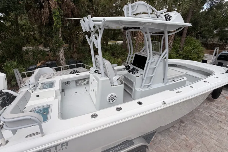 Slide: The Image of 2021 Costa Custom Boats 264HC, sleek design, spacious deck, advanced controls, parked outdoors. - 18