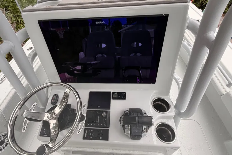 Slide: The Image of Helm of 2021 Costa Custom Boats 264HC with steering wheel and navigation controls. - 15