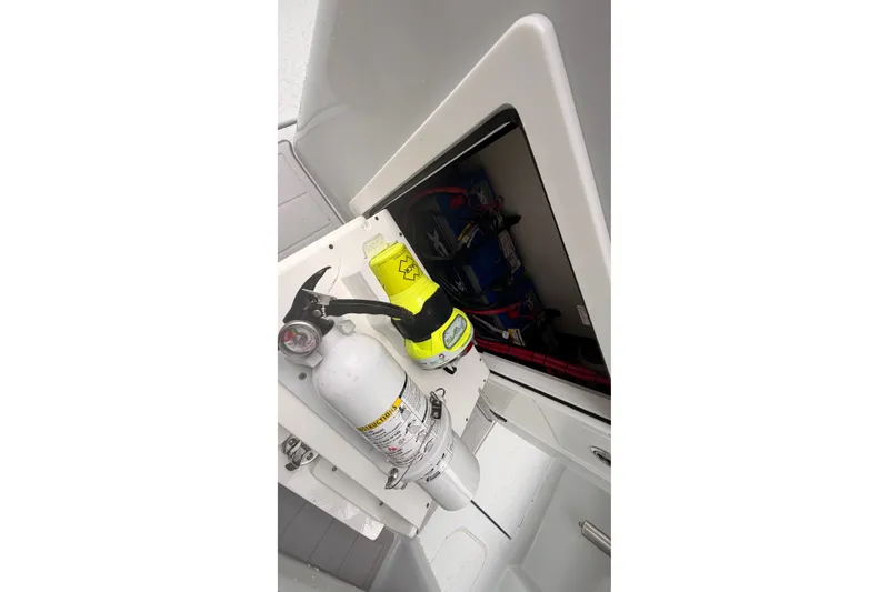 Slide: The Image of Storage compartment in a 2021 Costa Custom Boats 264HC, featuring safety equipment. - 39