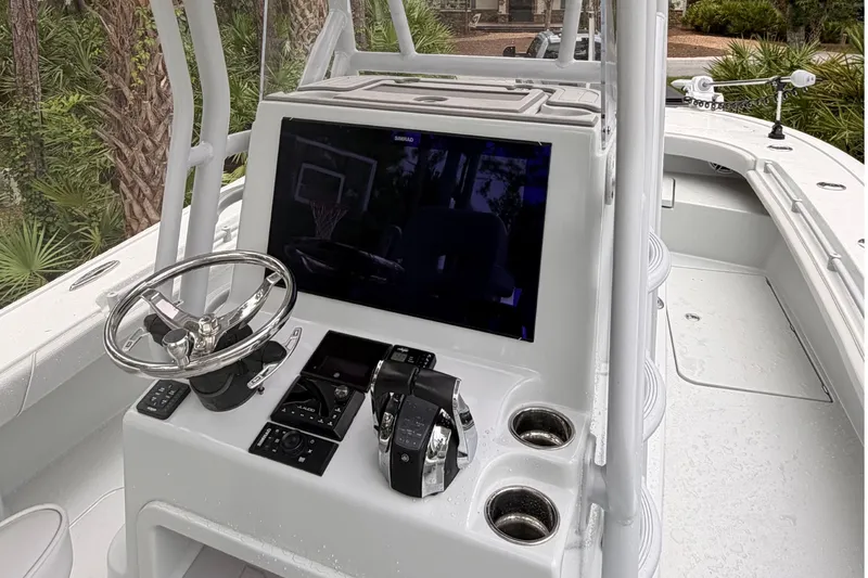 Slide: The Image of 2021 Costa Custom Boats 264HC helm with steering wheel and control panel. - 14