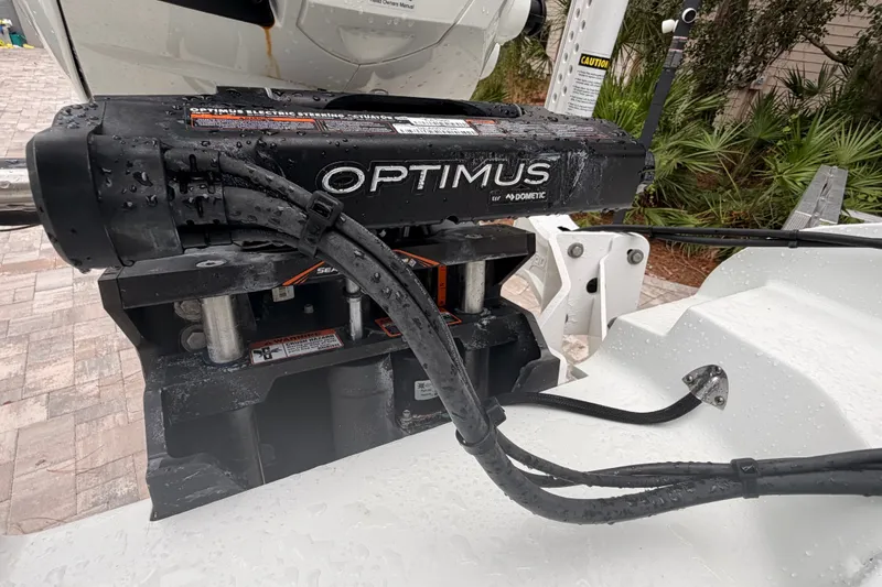 Slide: The Image of Optimus steering system on 2021 Costa Custom Boats 264HC, wet with water droplets. - 37