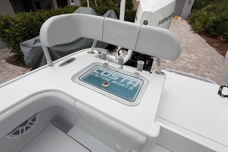 Slide: The Image of 2021 Costa Custom Boats 264HC deck with seating and storage compartment. - 8
