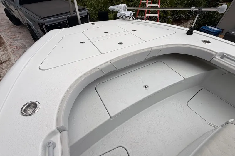 Slide: The Image of 2021 Costa Custom Boats 264HC deck with storage compartments and fishing equipment. - 19