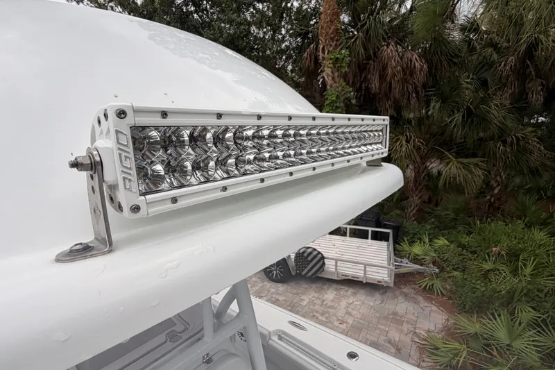 Slide: The Image of LED light bar on 2021 Costa Custom Boats 264HC, surrounded by lush greenery. - 33