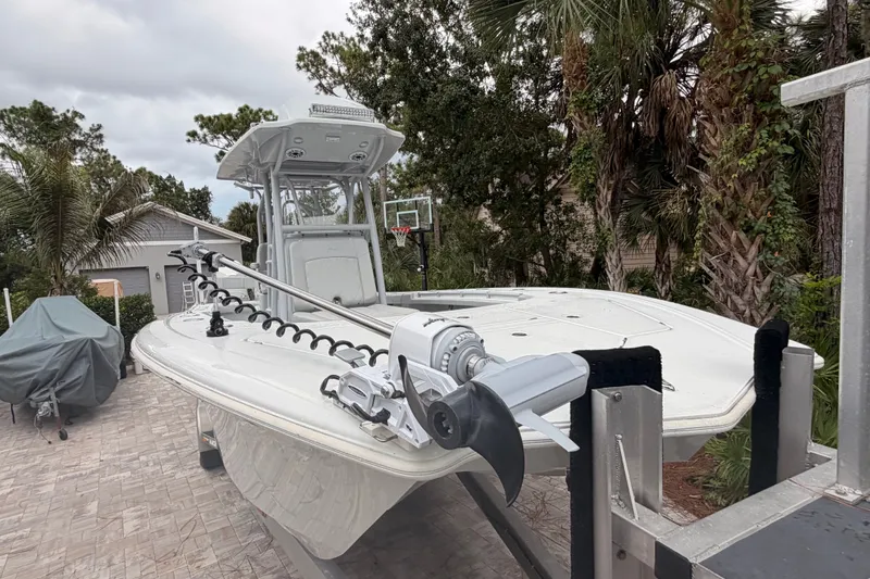 Slide: The Image of 2021 Costa Custom Boats 264HC on trailer, surrounded by trees and residential area. - 6