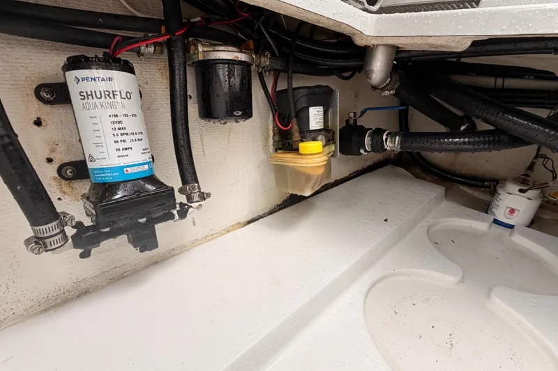 Slide: The Image of Engine compartment of 2021 Costa Custom Boats 264HC, featuring Shurflo Aqua King II pump. - 34