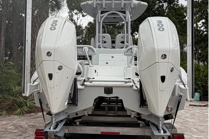 Slide: The Image of 2021 Costa Custom Boats 264HC with dual 300 horsepower engines, rear view on trailer. - 27