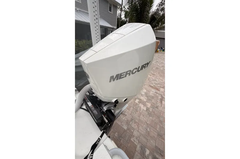 Slide: The Image of Mercury outboard engine on 2021 Costa Custom Boats 264HC, parked on brick driveway. - 11