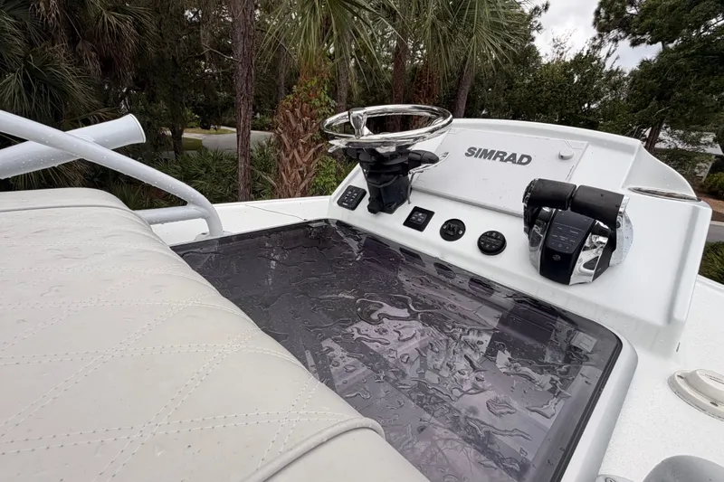 Slide: The Image of Helm of 2021 Costa Custom Boats 264HC with Simrad electronics, featuring a sleek design. - 13