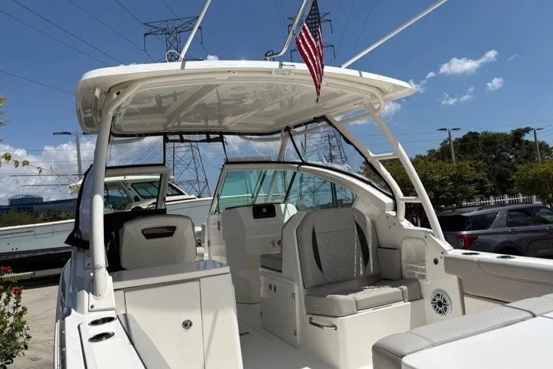 Slide: The Image of 2025 Pursuit DC 266 Dual Console boat with seating, under a clear blue sky. - 5