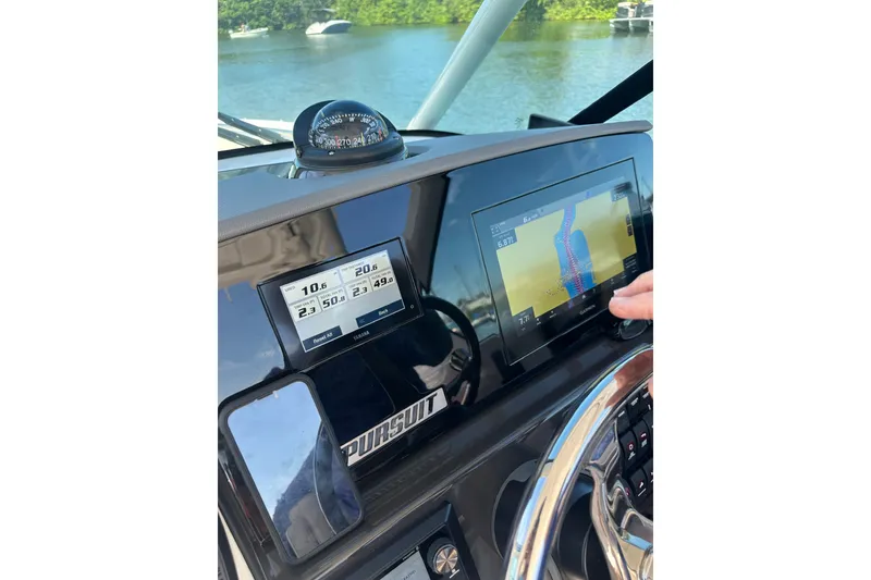 Slide: The Image of Dashboard of 2025 Pursuit DC 266 Dual Console with navigation screens. - 8