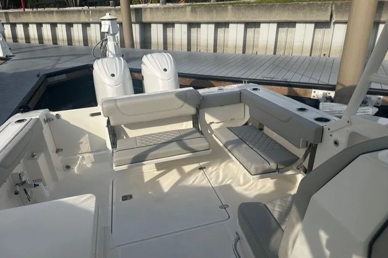Slide: The Image of 2025 Pursuit DC 266 Dual Console boat interior with seating and deck view. - 6