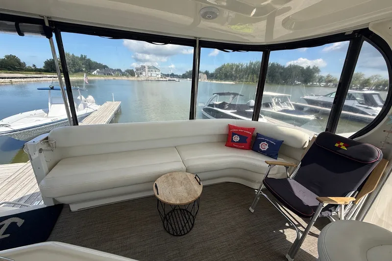 Slide: The Image of Interior of 2007 Sea Ray 40 Motor Yacht with white seating and marina view. - 34