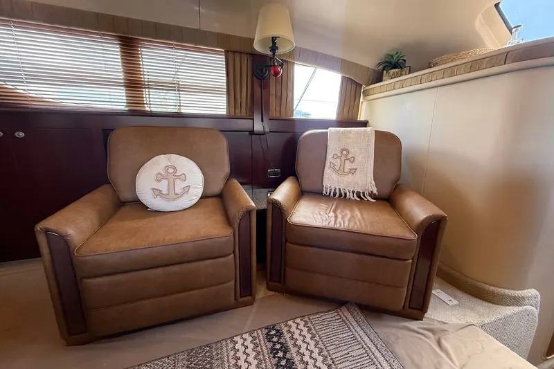 Slide: The Image of Interior of 2007 Sea Ray 40 Motor Yacht with two brown armchairs and nautical decor. - 60