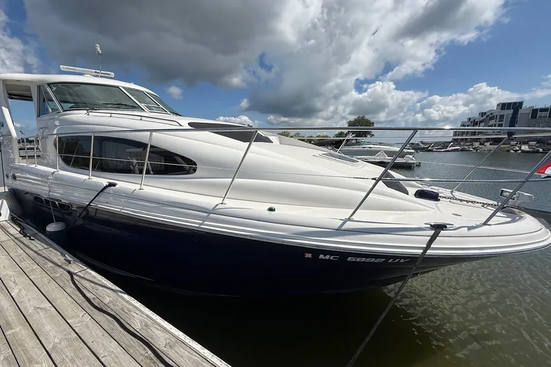 Slide: The Image of 2007 Sea Ray 40 Motor Yacht docked at marina under cloudy sky. - 13