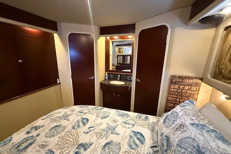 Slide: The Image of Interior of 2007 Sea Ray 40 Motor Yacht bedroom with nautical-themed bedding. - 90