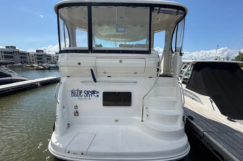 Slide: The Image of 2007 Sea Ray 40 Motor Yacht docked, rear view with "Blue Sky" name visible. - 3