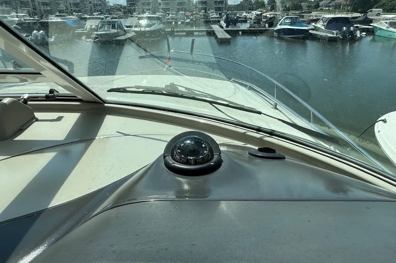 Slide: The Image of 2007 Sea Ray 40 Motor Yacht helm with compass, docked in marina. - 50