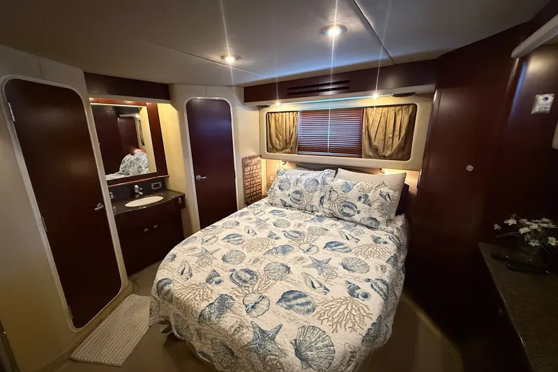 Slide: The Image of Luxurious bedroom interior of 2007 Sea Ray 40 Motor Yacht with nautical-themed bedding. - 89