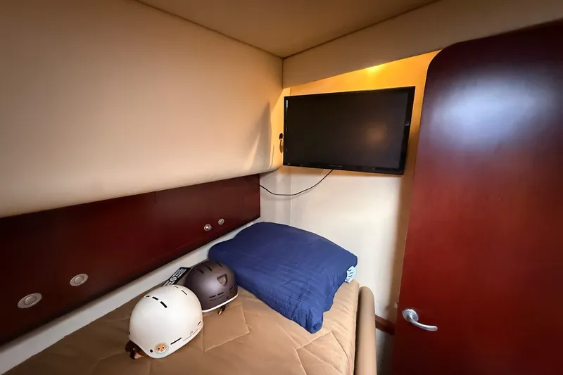 Slide: The Image of Cozy cabin interior of 2007 Sea Ray 40 Motor Yacht with TV and helmets. - 81